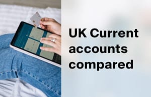Person holding a bank card and a tablet with a banking app open, comparing UK current accounts