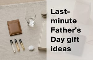 Flat-lay of last-minute Father's Day gifts including a leather card holder, whisky glass, fragrance vials and a notebook