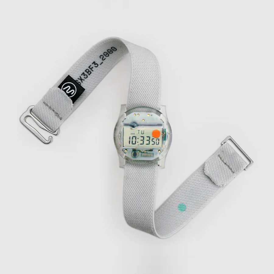 CW&T Solid State Watch UK in clear resin showing 10:33 and the orange leap-year dot, with grey Hook Strap unbuckled