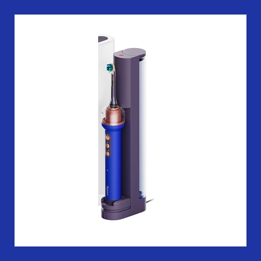 Dyson CameraJet electric toothbrush in Ceramic Ultra Blue, standing in its purple refill dock