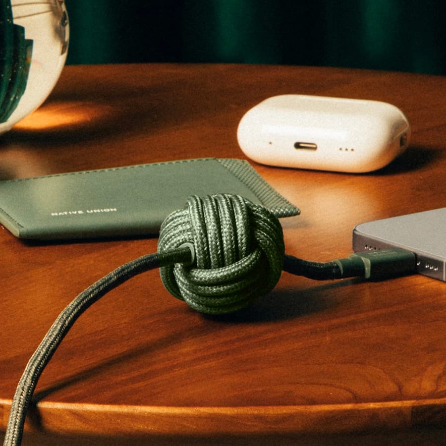 Green Native Union Anchor Cable 240W with weighted knot on desk charging iPhone