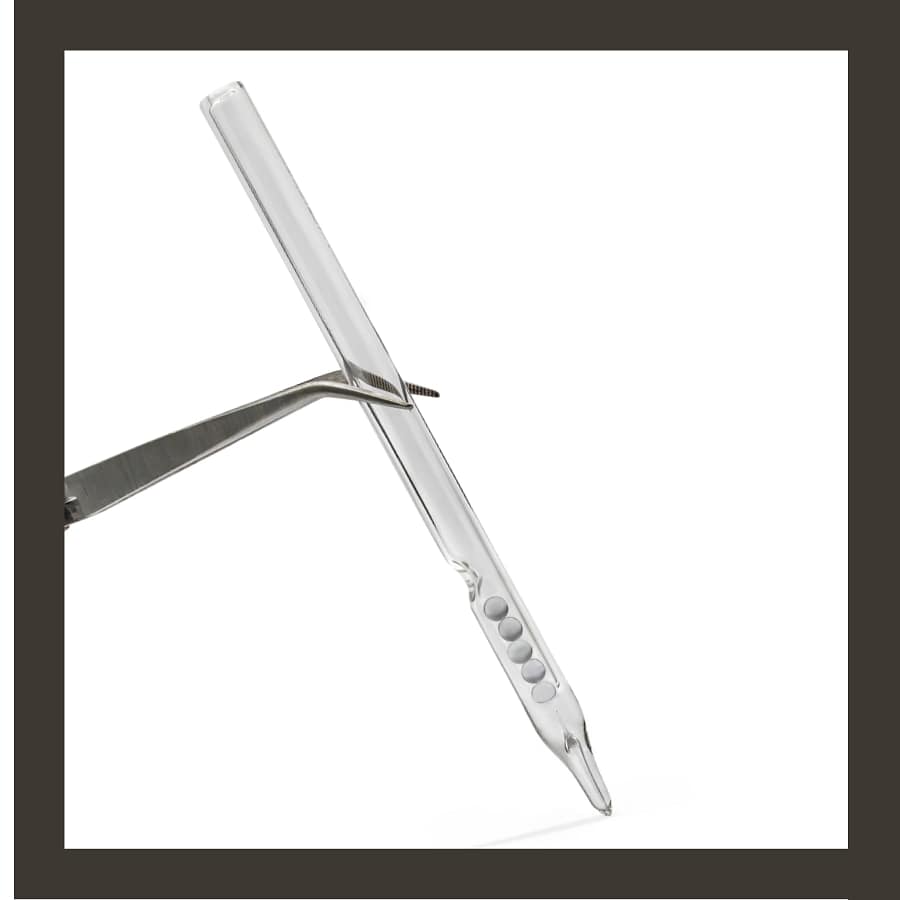 Requin Renard glass pen B1 held in forceps, showing the bevelled glass nib and five reservoir beads on white.
