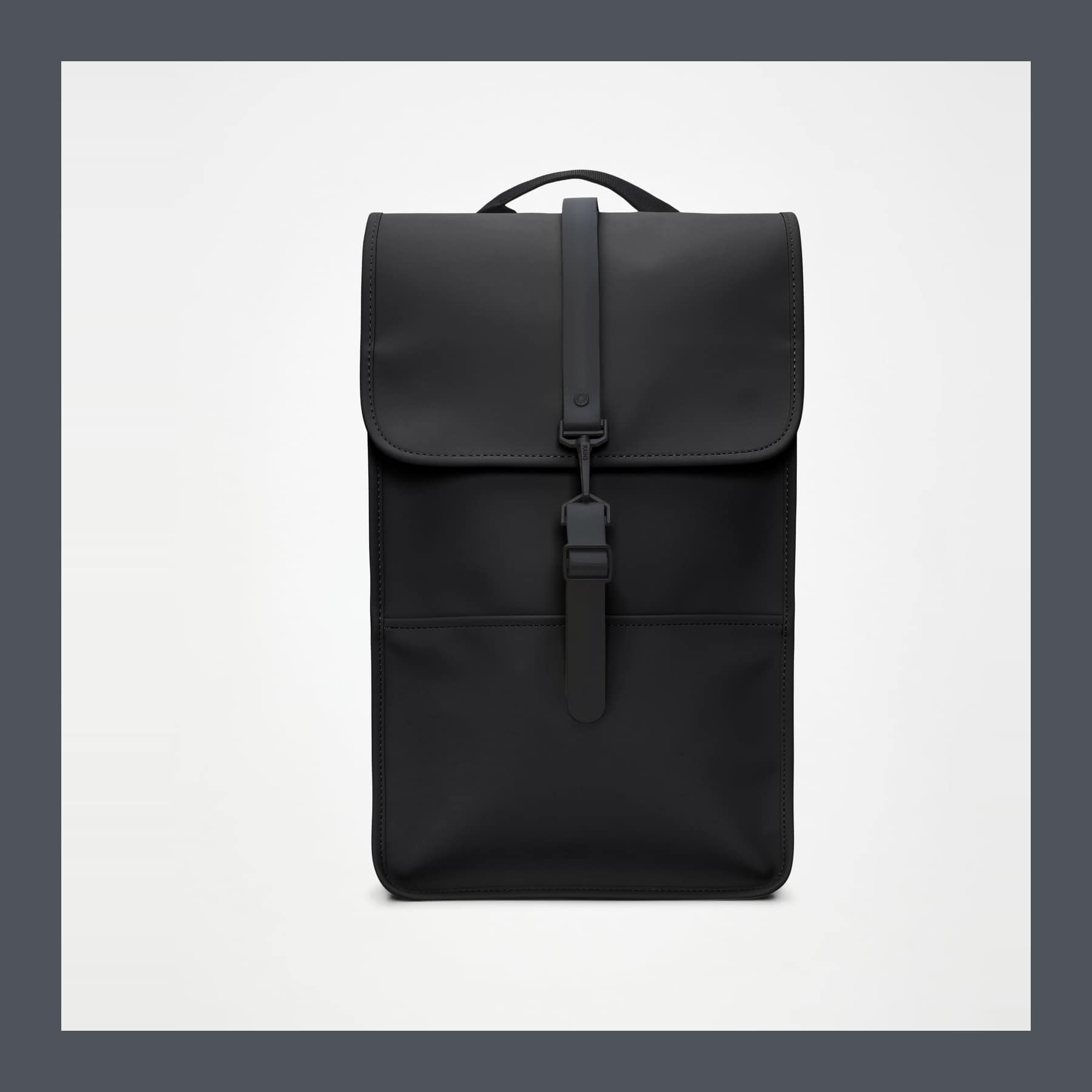 The black Rains Backpack photographed front on, showing the flap and hook closure