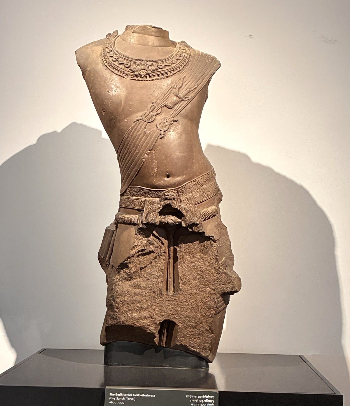 Sandstone torso of the Bodhisattva Avalokiteshvara, known as the Sanchi Torso, on a black plinth