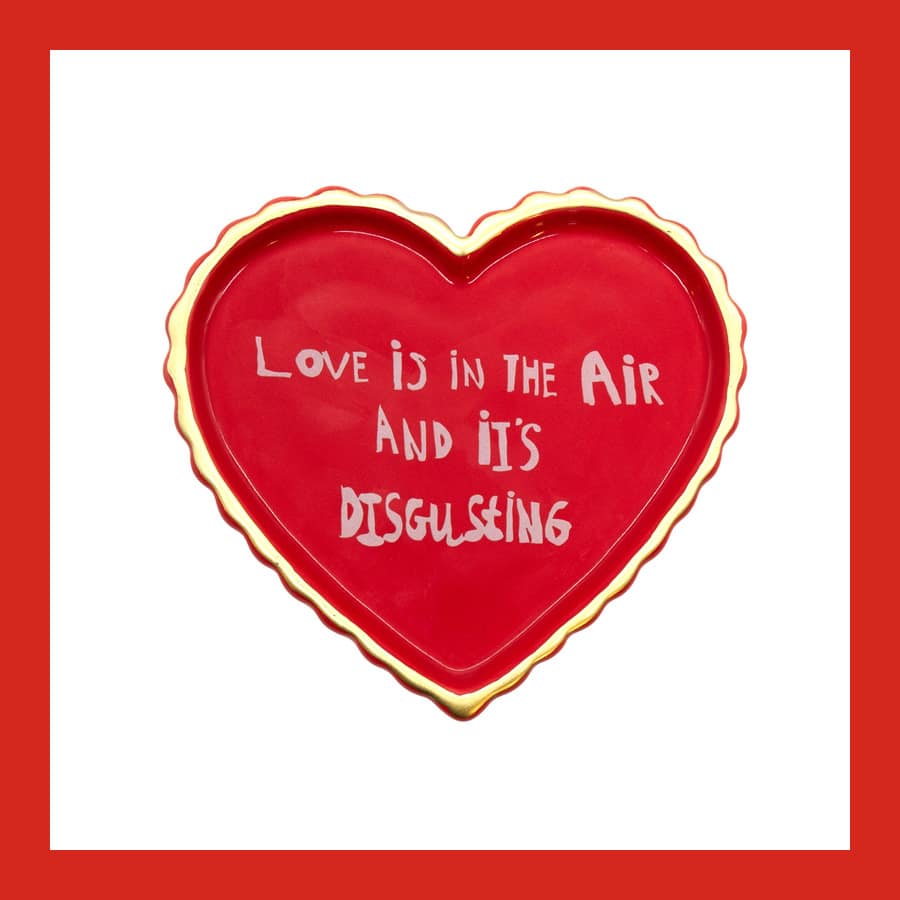 ARTHOUSE Unlimited heart-shaped ceramic trinket tray reading Love is in the Air and it's disgusting