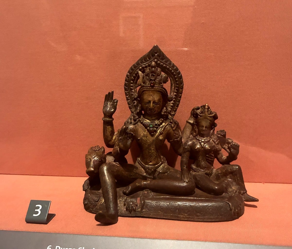 Small gilded copper sculpture of Shiva and Parvati seated on a cushion throne with Nandi the bull beside them